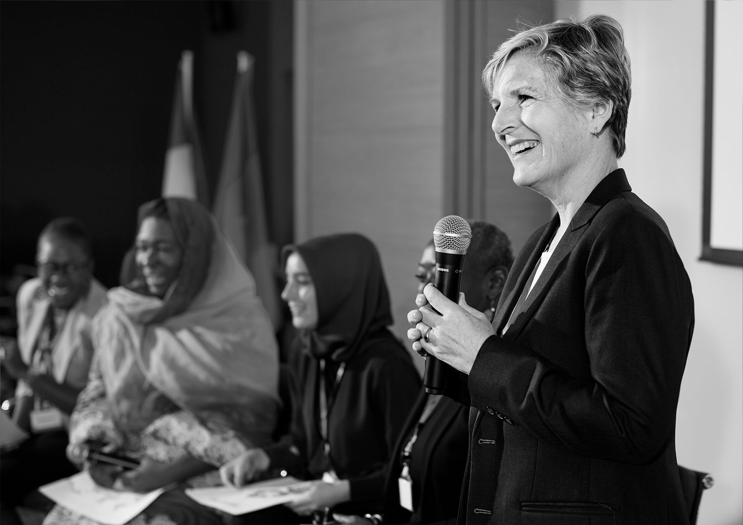 woman speaking in seminar with table of women